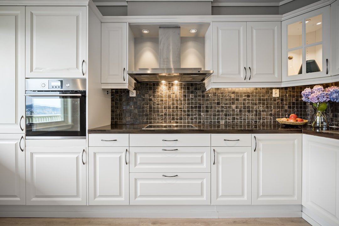 Classic white kitchen cabinets with raised panel doors and black countertops