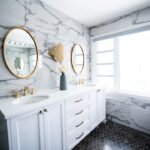 Elegant double sink bathroom with marble countertops and dual mirrors