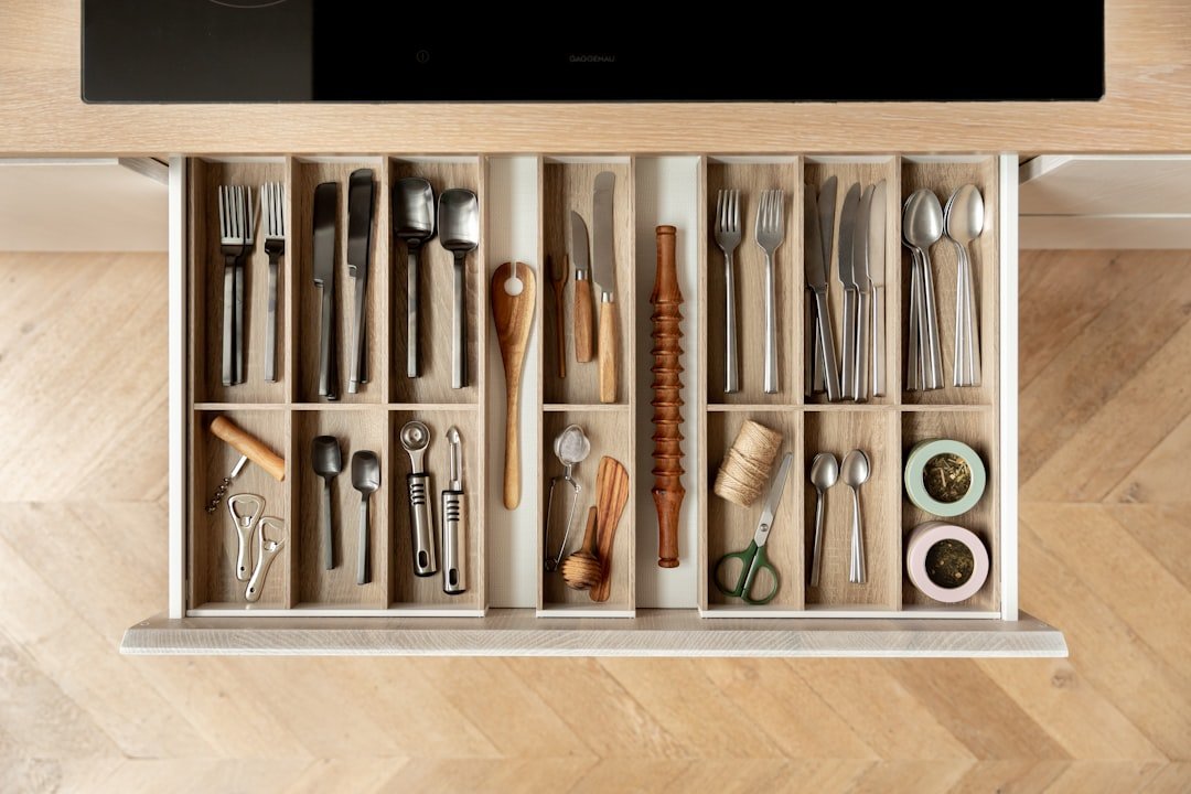 Organized kitchen pull-out drawer with wooden inserts and cutlery