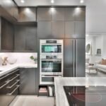 Shaker gray kitchen cabinets with modern stainless steel appliances and marble countertops