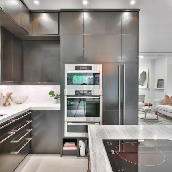 Shaker gray kitchen cabinets with modern stainless steel appliances and marble countertops