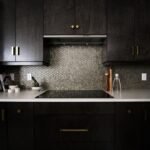 Dark navy blue kitchen cabinets with ceramic stovetop