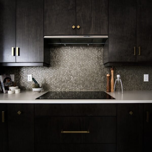 Dark navy blue kitchen cabinets with ceramic stovetop