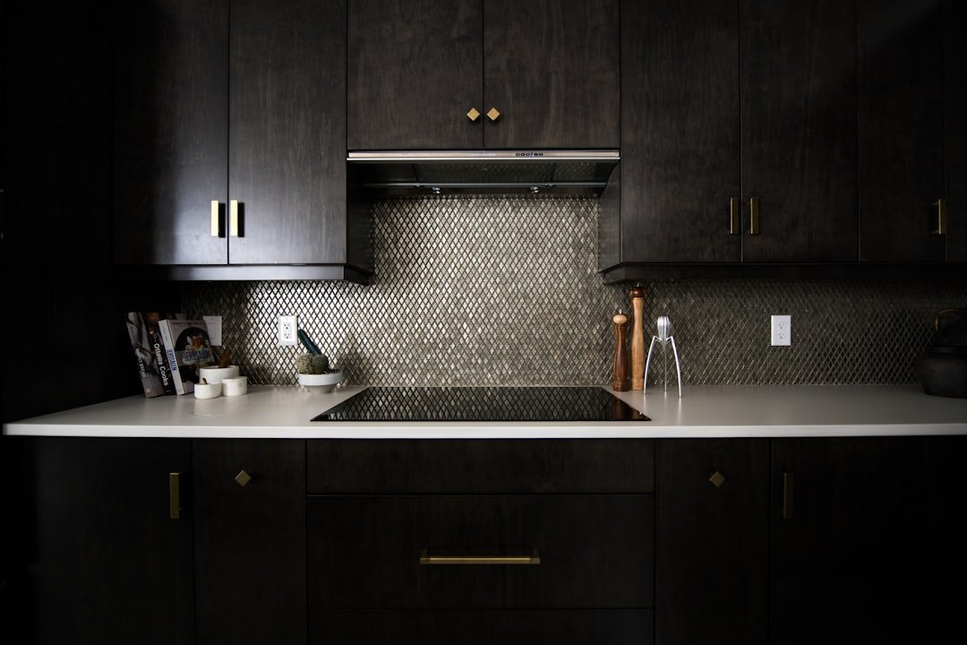 Dark navy blue kitchen cabinets with ceramic stovetop