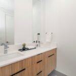 Modern single bathroom vanity with white cabinet and mirror